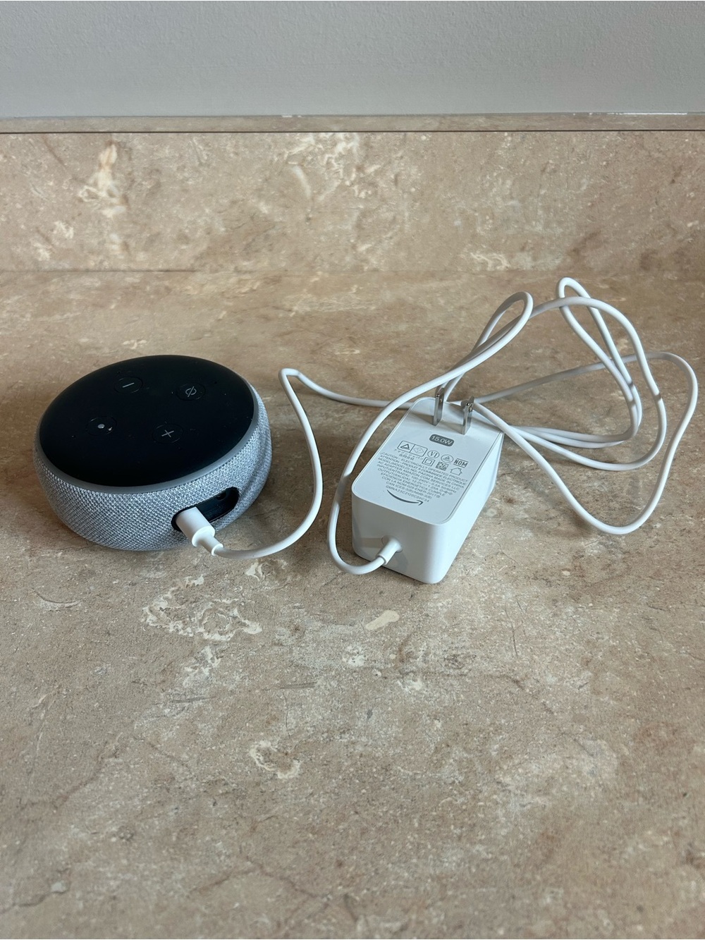 Amazon Echo Dot smart speaker base in black and gray